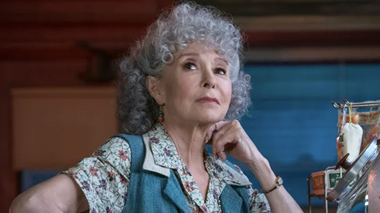 Rita Moreno as Valentina posing and smirking in Steven Spielberg's West Side Story