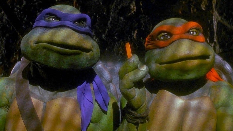 Donnie and Mikey standing together in the sewer in Teenage Mutant Ninja Turtles (1990)