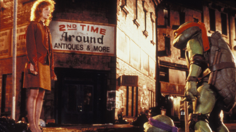 Judith Hoag's April O'Neal meeting Raph and Leo at a sewer drain in Teenage Mutant Ninja Turtles (1990)
