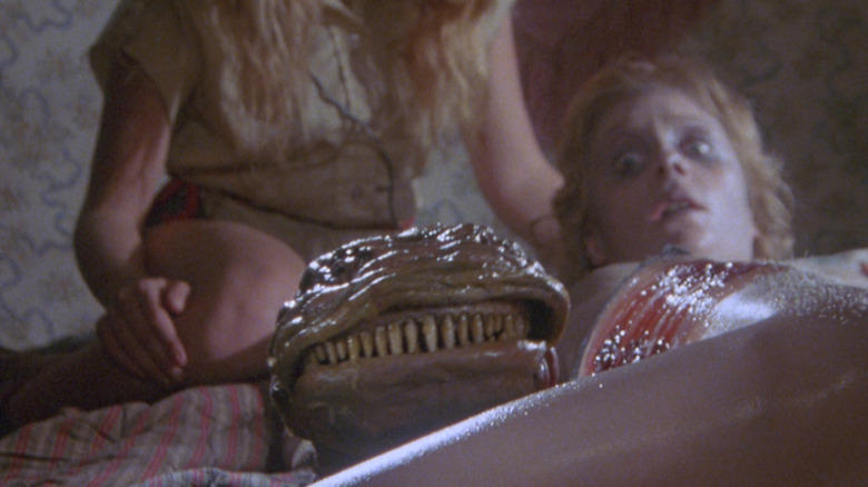 A creature emerges in Parasite (1982)