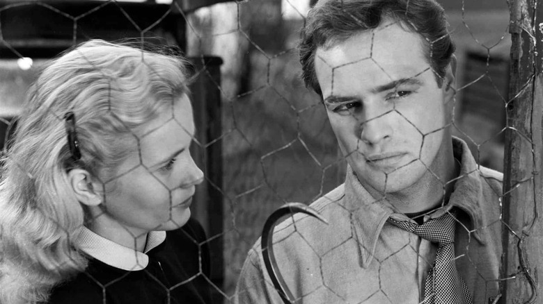 Edie and Terry behind a chicken wire fence in On the Waterfront