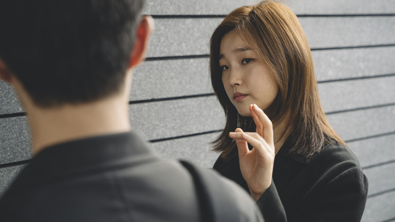 Kim Ki-jung gestuing to her brother in Parasite