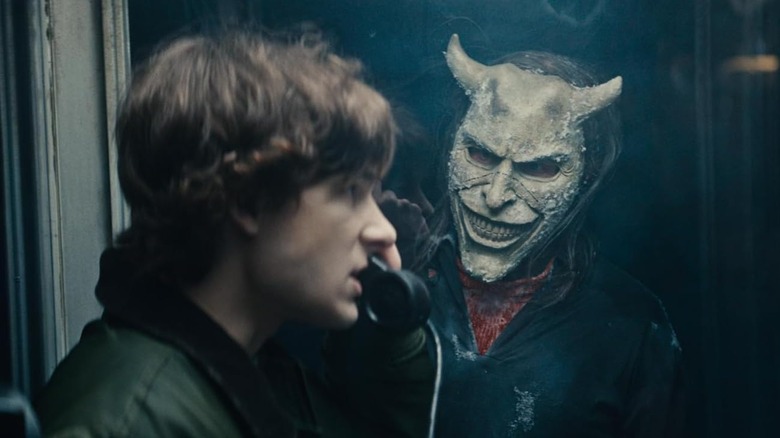 The Grabber looking at Finn in a phone booth in Black Phone 2