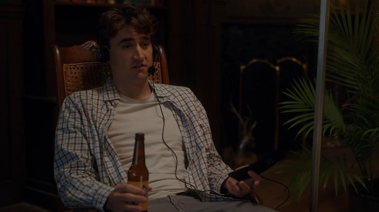 Jon Michael Simpson Will sitting in a chair and drinking a beer in Sorry About the Demon