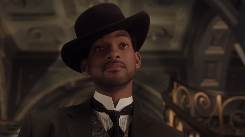 Will Smith's James T. West is seen from a low angle as he stands in a grand hall in Wild Wild West