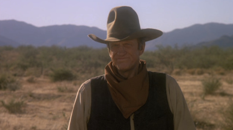 James Arness' Thomas Dunson grimaces in the desert in Red River
