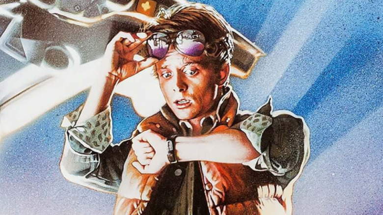 Marty McFly looking at his watch standing by the DeLorean on the poster for Back to the Future
