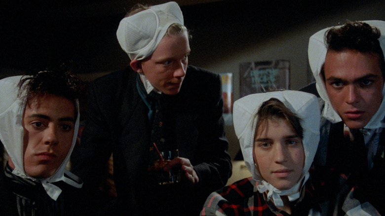 Robert Downey Jr. as Ian, Anthony Michael Hall as Gary, Ilan Mitchell-Smith as Wyatt, and Robert Rusler as Max with bras on their heads in Weird Science