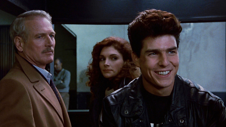 Paul Newman as Fast Eddie Felson and Mary Elizabeth Mastrantonio as Carmen looking in concern at a grinning Tom Cruise as Vincent Lauria in The Color of Money