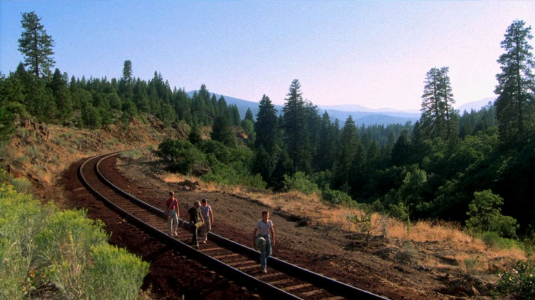 River Phoenix's Chris Chambers, Wil Wheaton's Gordie Lachance, Corey Feldman's Teddy Duchamp, and Jerry O'Connell's Vern Tessio walk along a train track in Stand By Me