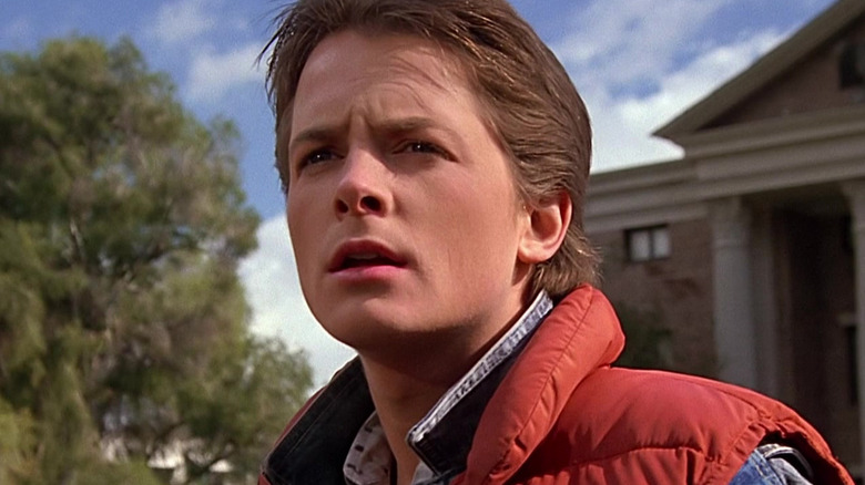Michael J. Fox as Marty McFly stands in front of the clocktower in Back to the Future