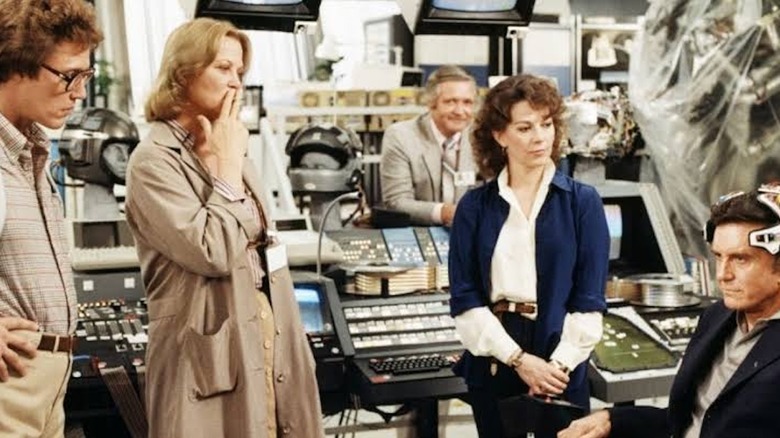 Christopher Walken as Michael Brace, Louise Fletcher as Lillian Reynolds, and Natalie Wood as Karen Brace watch Cliff Robertson as Alex Terson try out the brain-computer interface in Brainstorm