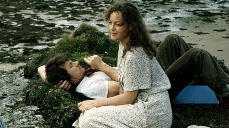 Harvey Keitel as Roddy and Romo Schneider as Katherine Mortenhoe relax by a river in Death Watch