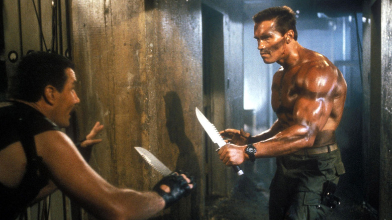 John Matrix, shirtless with a huge hunting knife fighting a goon in Commando