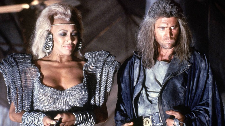 Aunty Entity and Max looking at something in Mad Max: Beyond Thunderdome