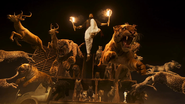 N. T. Rama Rao Jr. as Ram letting the animals loose at the manor in RRR