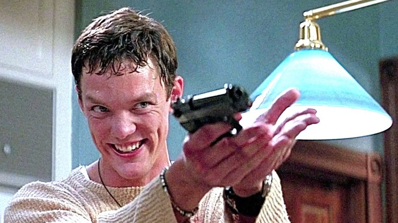 Scream, Matthew Lillard as Stu, menacingly pointing a gun