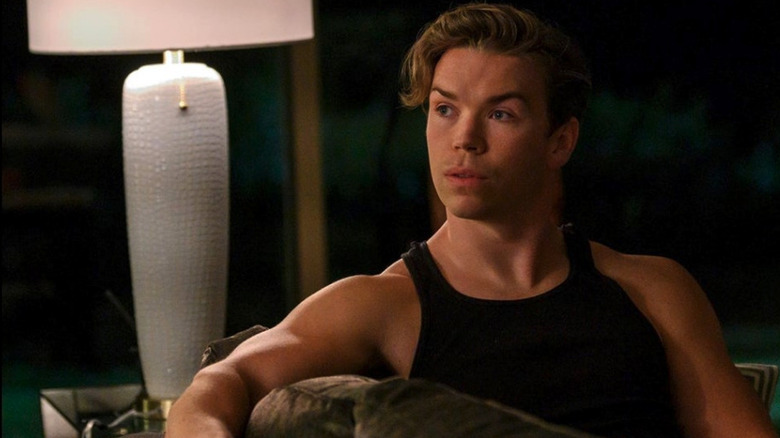 Will Poulter as Billy Cutler sits on a couch in Dopesick