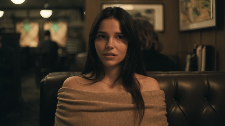 Nikki sitting in a restaurant booth in Obsession