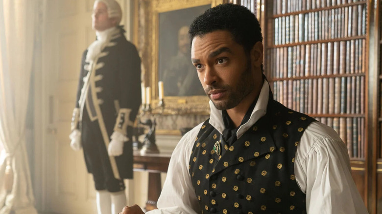 Simon raising an eyebrow in his library on Bridgerton