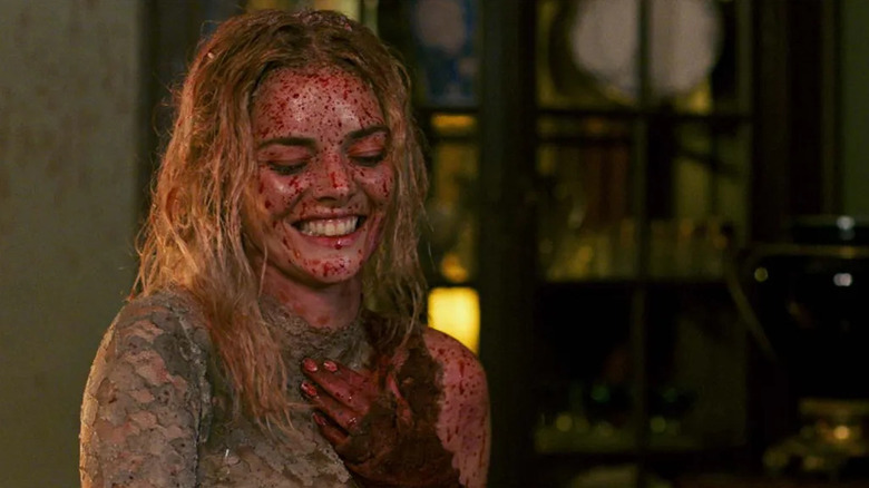 Samara Weaving as Grace, covered in blood and laughing, in Ready or Not
