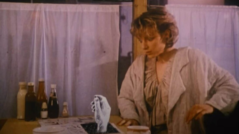 The Girl seeing a hand coming out of a comic page in a-ha's Take On Me music video.