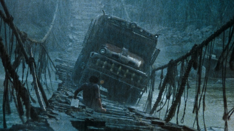 A man on a suspension bridge looking at a truck in Sorcerer