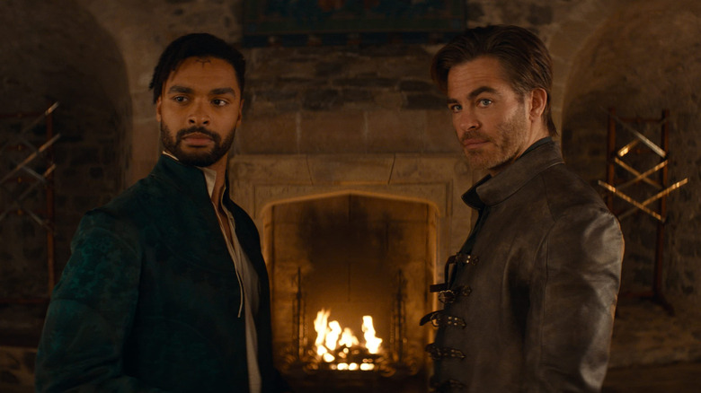 Regé-Jean Page as Xenk Yendar and Chris Pine as Ed Darvis standing in front of a fireplace in Dungeons & Dragons: Honor Among Thieves