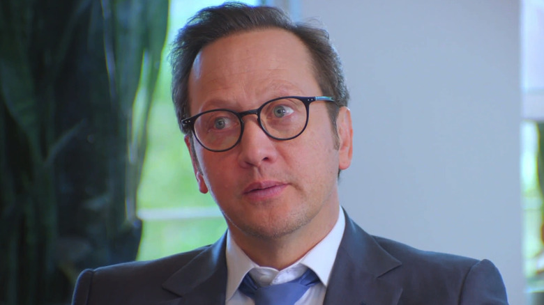Rob Schneider is seen as himself in closeup as he sits in an office in Real Rob