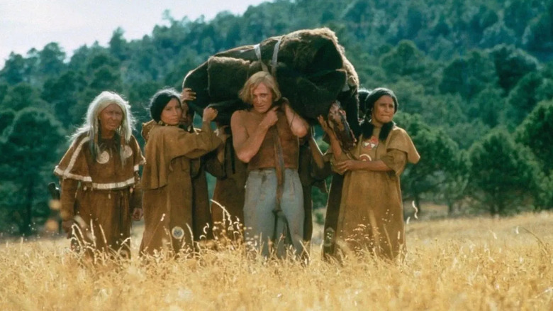 John Morgan (Richard Harris) and tribespeople walking through a field in "A Man Called Horse."