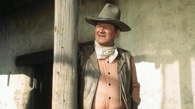 Cord McNally (John Wayne) standing on a porch in "Rio Lobo"