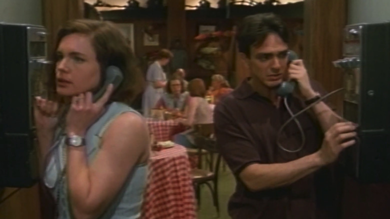 Elizabeth McGovern's Jessie Kent stands next to Hank Azaria's Craig Schaeffer as they talk on payphones in If Not for You