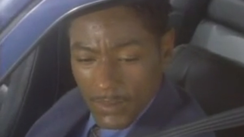 Giancarlo Esposito's Paul Gigante looks down as he sits in a car in Bakersfield PD