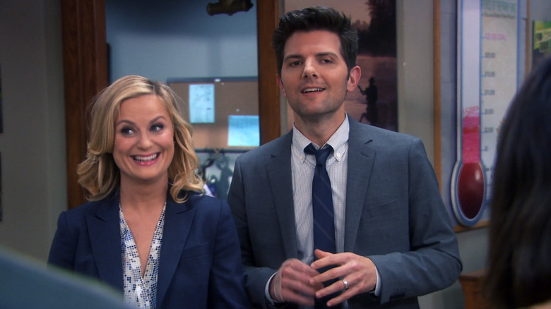 Ben and Leslie both smiling nervously on Parks and Recreation