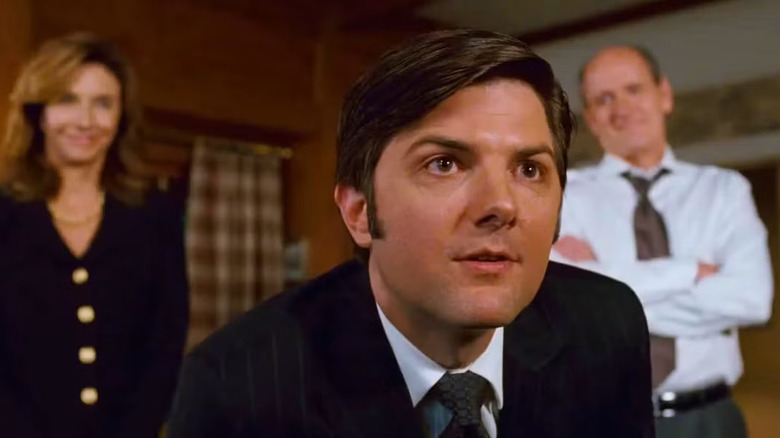 Derek leaning forward with his parents behind him in Step Brothers