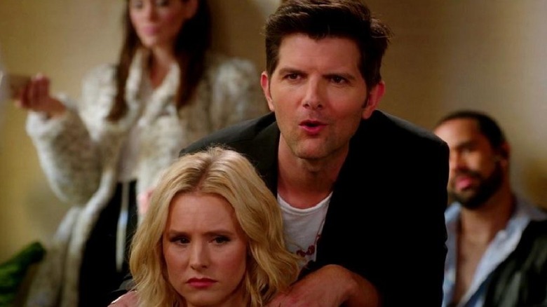 Trevor with his hands on Eleanor's shoulders from behind on The Good Place