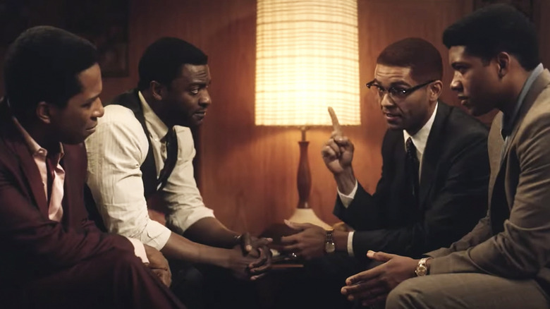Sam Cooke, Jim Brown, Cassius Clay, and Malcolm X sit opposite each other on beds in a hotel room in One Night in Miami...
