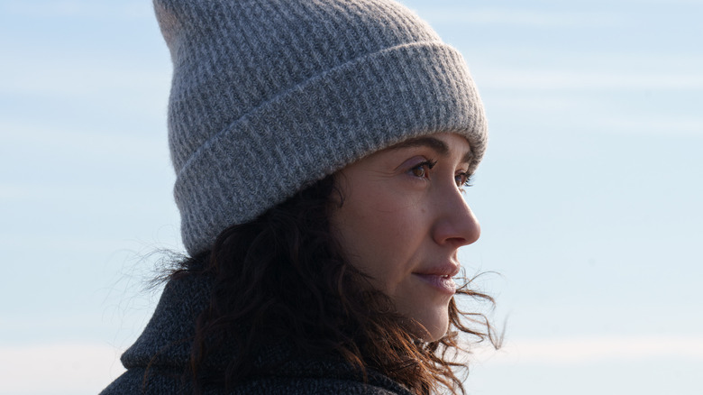 Alice wearing a gray hat looking over her shoulder in Furious