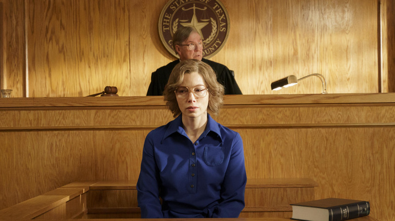 Candy in court wearing a purple shirt and glasses on Candy