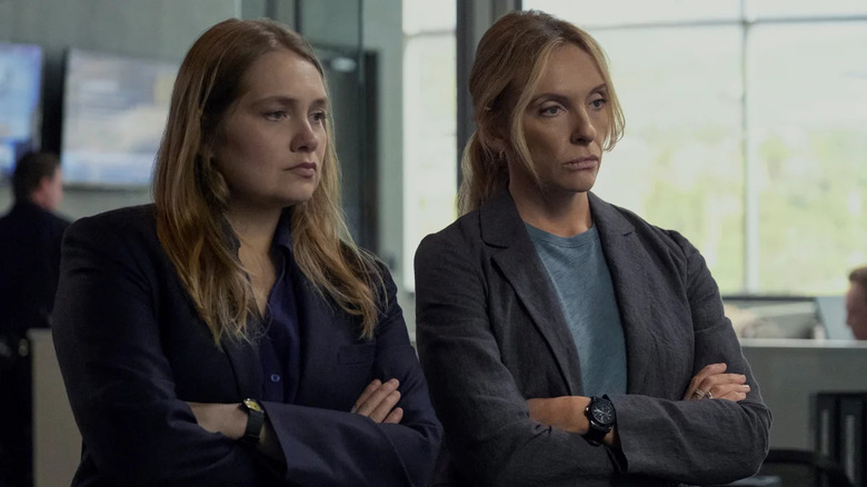 Karen and Grace in the office looking at someone on Unbelievable