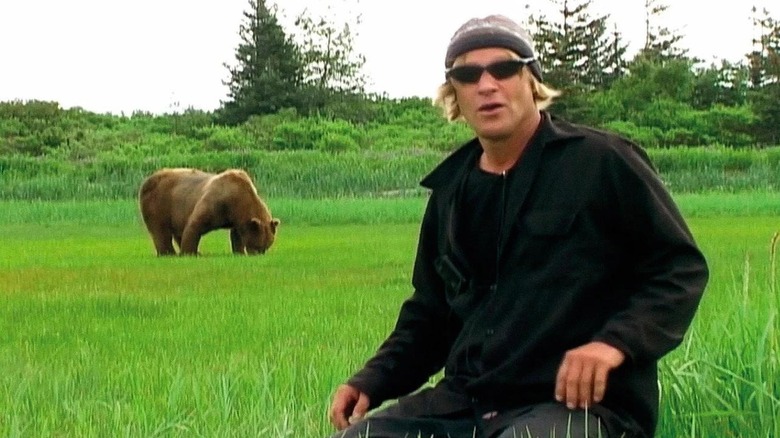 Timothy Treadwell and a grizzly bear in a field in Grizzly Man