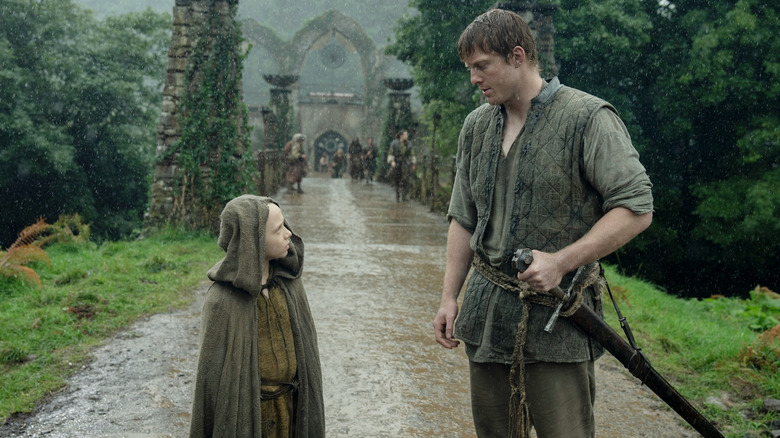 Dexter Sol Ansell as Egg standing opposite Peter Claffey as Dunk in the rain in A Knight of the Seven Kingdoms