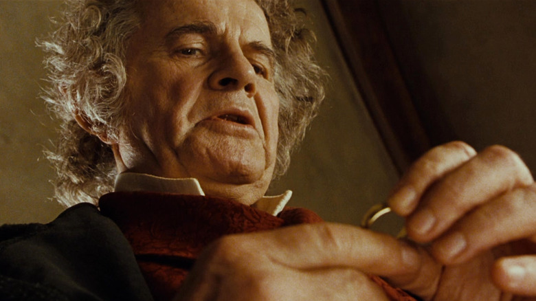 Bilbo looking down at his ring in The Fellowship of the Ring