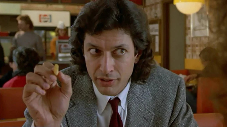 Seth Brundle holding french fry in The Fly