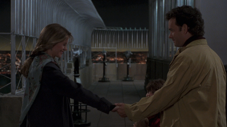 Meg Ryan's Annie Reed holds the hand of Tom Hanks' Sam Baldwin on the observation deck of the Empire State Building in Sleepless in Seattle