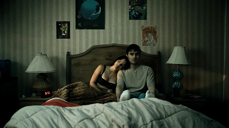 Nikki and Bear sitting on a bed in Obsession
