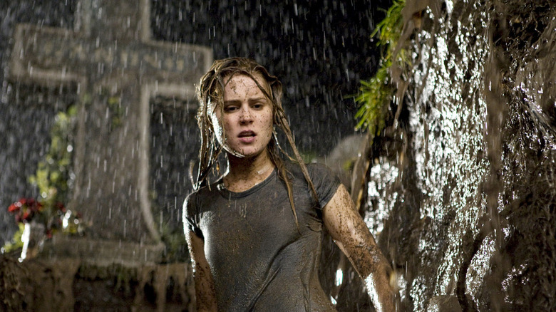Christine stands in an open grave in the rain in Drag Me to Hell