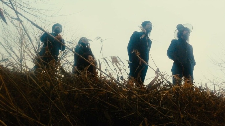 Five characters in the grasses in Night Fishing