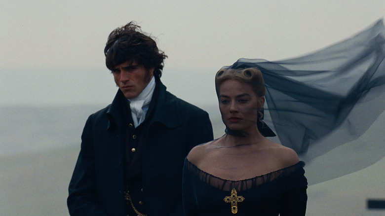 Heathcliff and Cathy in funeral attire by the side of a cliff in Wuthering Heights (2026)
