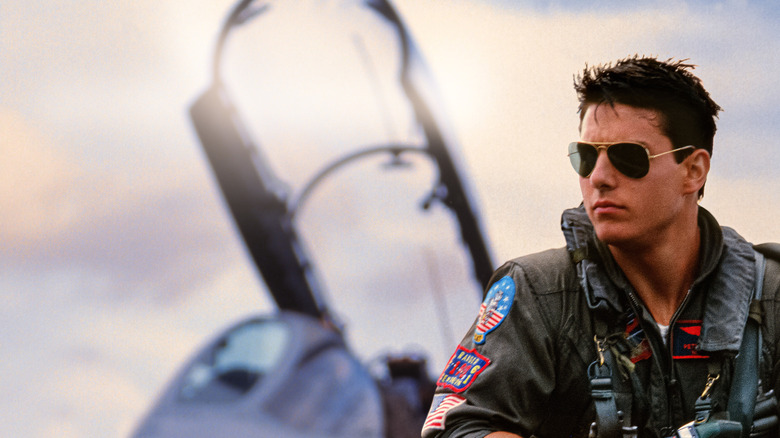 Maverick in front of an aircraft wearing sunglasses in Top Gun